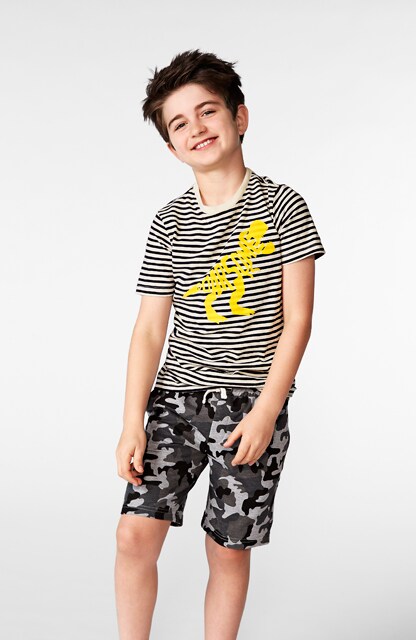 little boy in graphic tee and printed shorts little boy in graphic tee and printed shorts