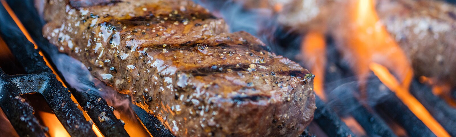 Cooked steak grilling on a grill