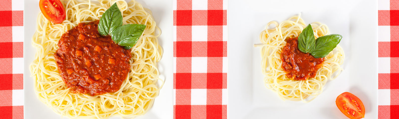 One plate with a large serving of spaghetti next to one plate with a smaller serving of spaghetti