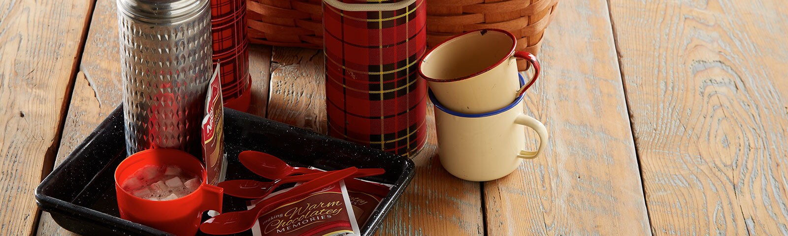 Hot cocoa in mugs and thermos